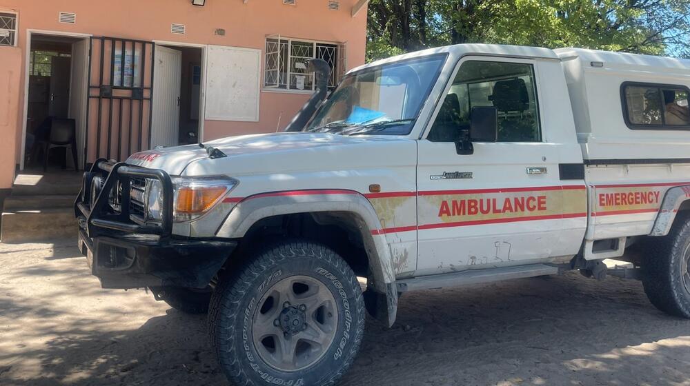 An ambulance parked outside of a hospital.