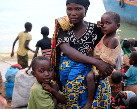 A woman and her two small children flee into Tanzania by boat.