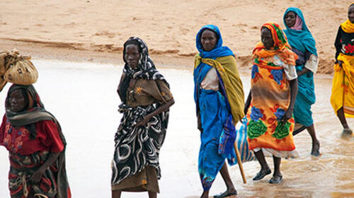 Displaced women are escorted by peacekeepers as they collect firewood in Sudan, in 2010. The women say they fear being assaulted when they leave their homes. Photo credit: UN Photo/Albert Gonz&aacute;lez Farran
