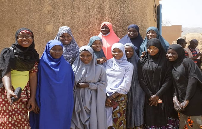 Twelve young women pose for a picture in their home region of Niger.