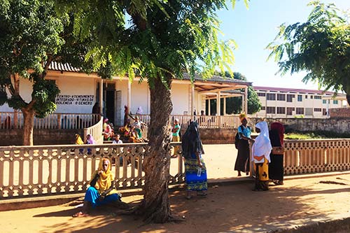 Women stand outside a service centre for survivors of violence in Mozambique.