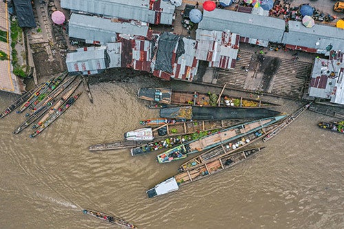 Boats are seen on a river, photographed from above.