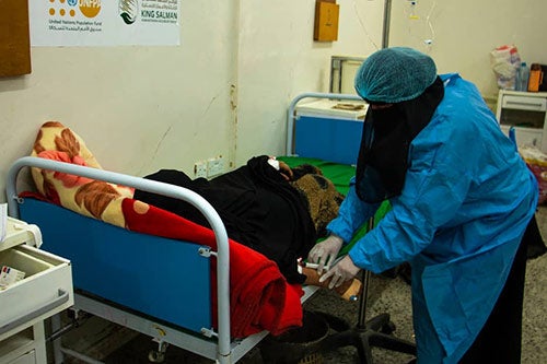 A health worker attends to a woman in labour. 