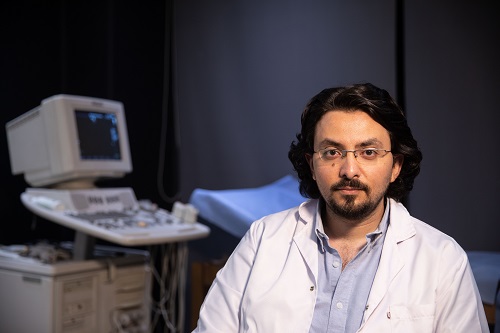 Dr. Diwar sits in an ultrasound room. 