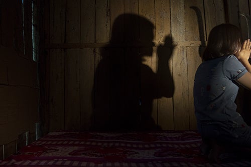 A photo shows the silhouette of a woman praying.