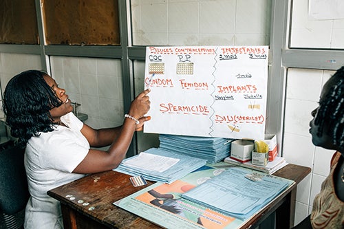 A nurse in Benin provides family planning counseling. Around the world, health systems affected by the pandemic may curtail such services. © UNFPA/Ollivier Girard