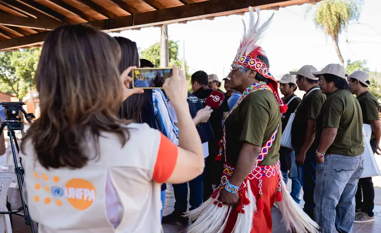 UNFPA photographer takes a picture of an indigenous person.