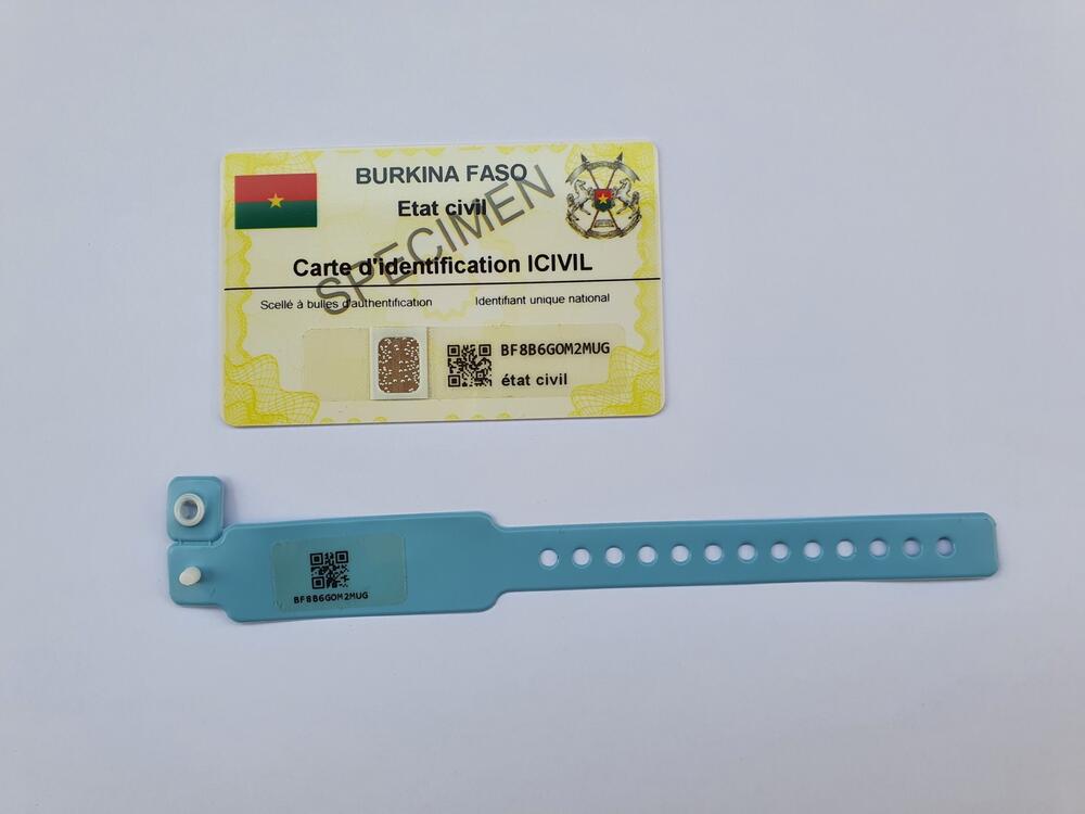 A yellow identification card and blue bracelet. 