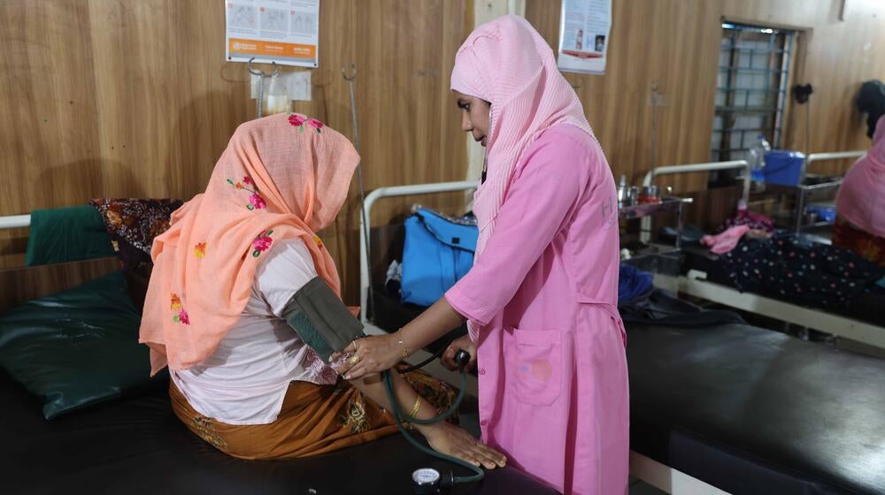 A medical worker assists a patient.