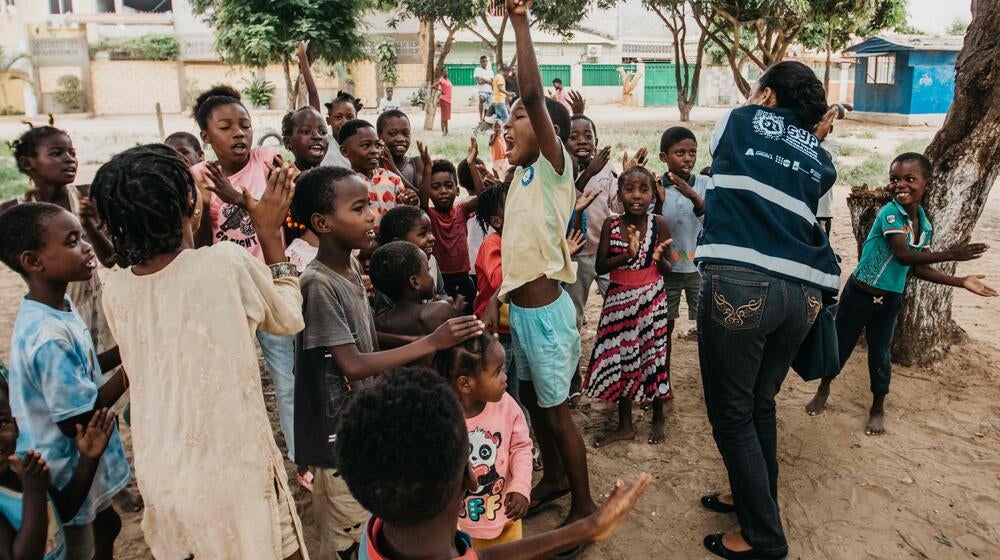 A group of children clap.