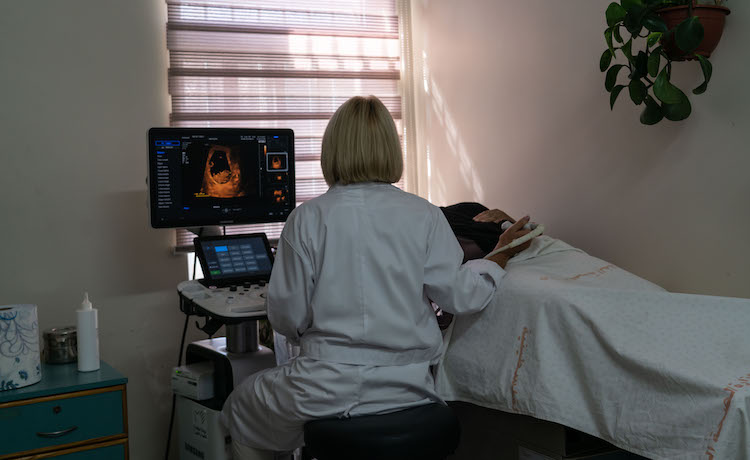 A woman receives an ultrasound. 