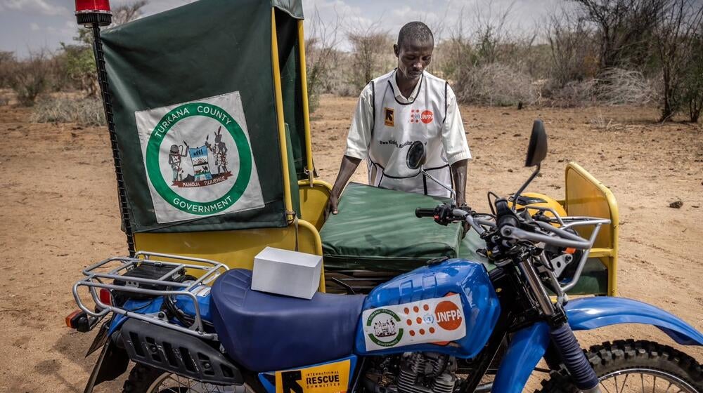 A healthcare worker sets up a motorbike ambulance.