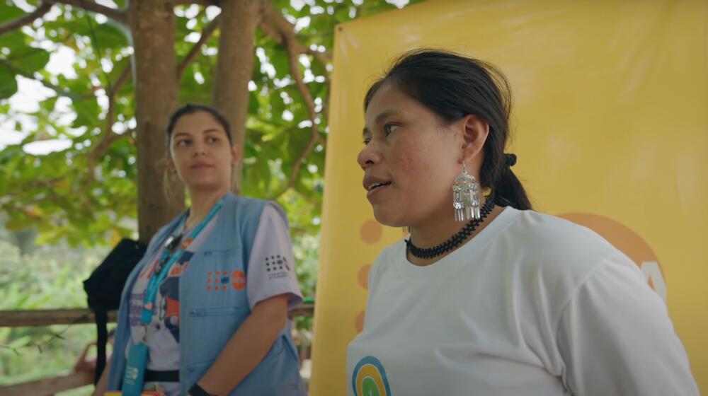 Dos mujeres, una trabajadora del UNFPA y una líder indígena, realizan una presentación a un grupo.
