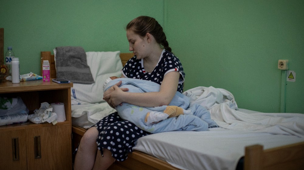 A woman holds her baby.