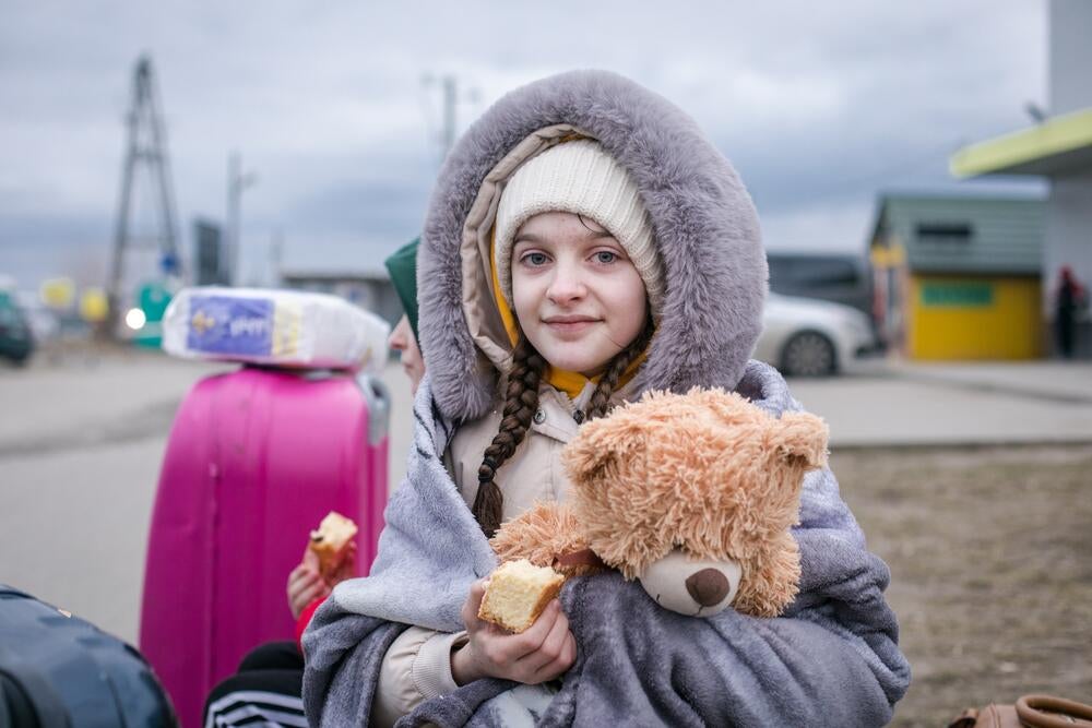 Girl in hood with teddy bear