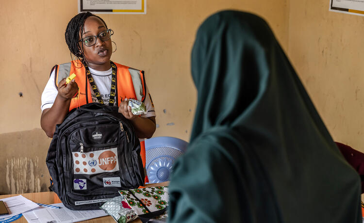 A woman holds supplies from a UNFPA dignity kit. 