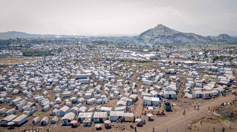 An aerial view photograph of makeshift tents in an internally displaced persons camp in rural DRC.