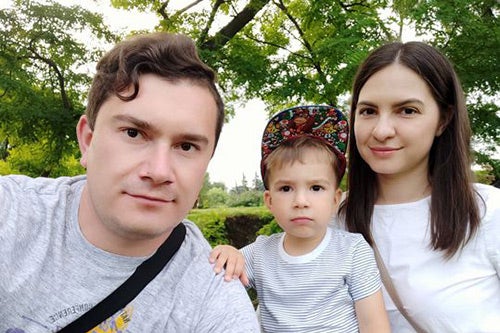 Anastasia Ciuleacu and Vitalie Maistru and their toddler son pose for a picture. 