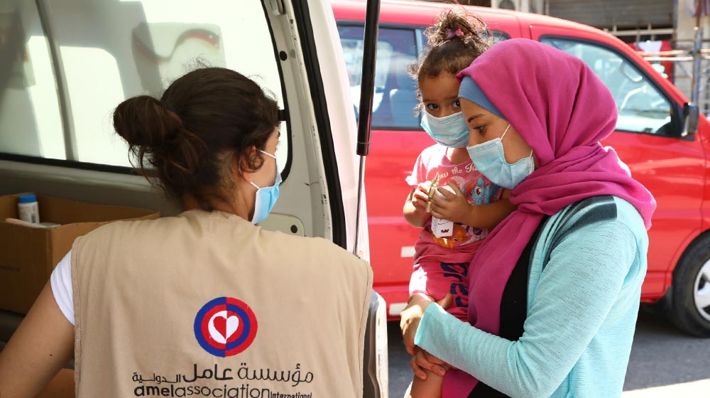 Beirut residents receive support from a mobile medical unit run by Amel Association, with support from UNFPA.