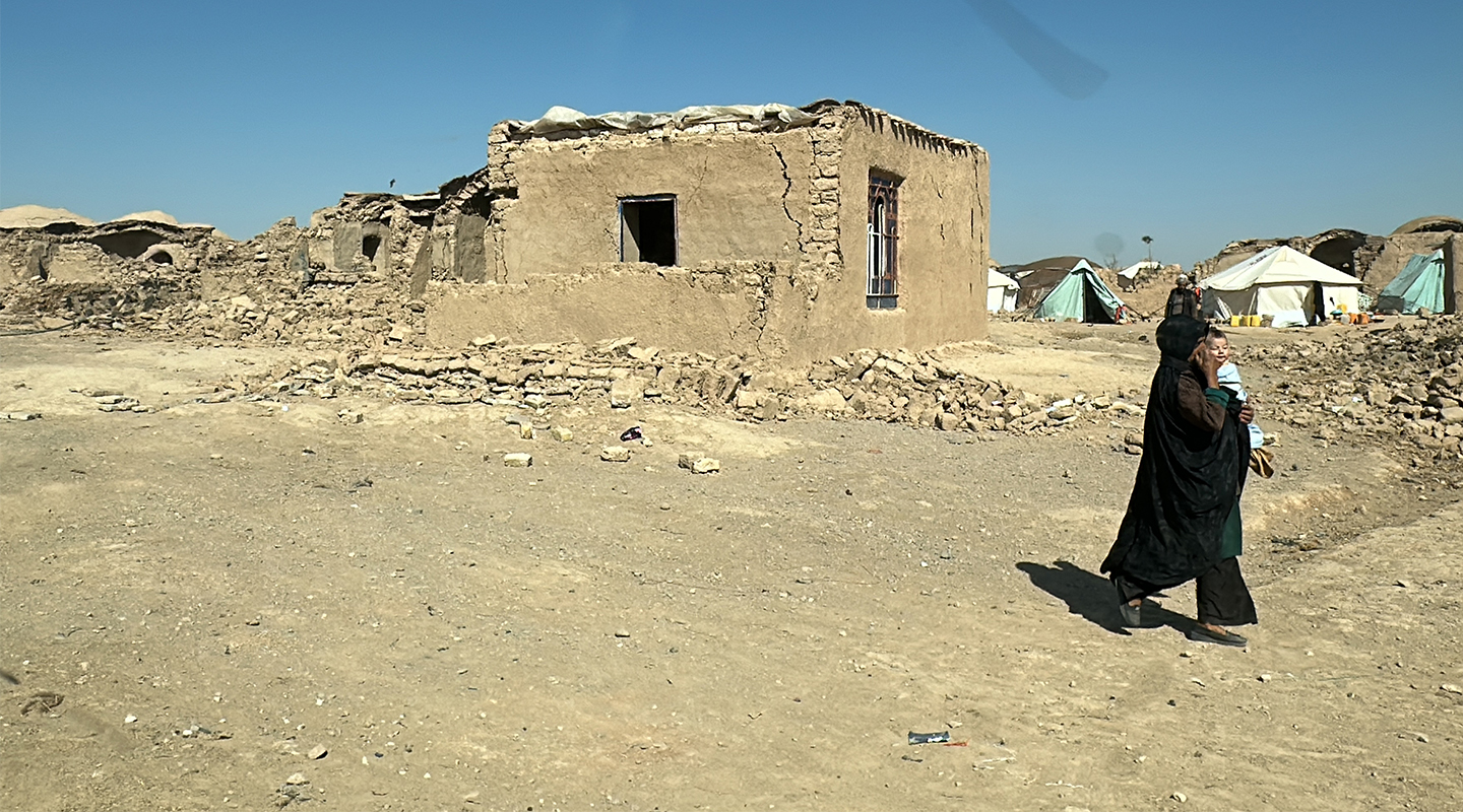 A survivor amid the rubble in the village of Nayeb Rafi.