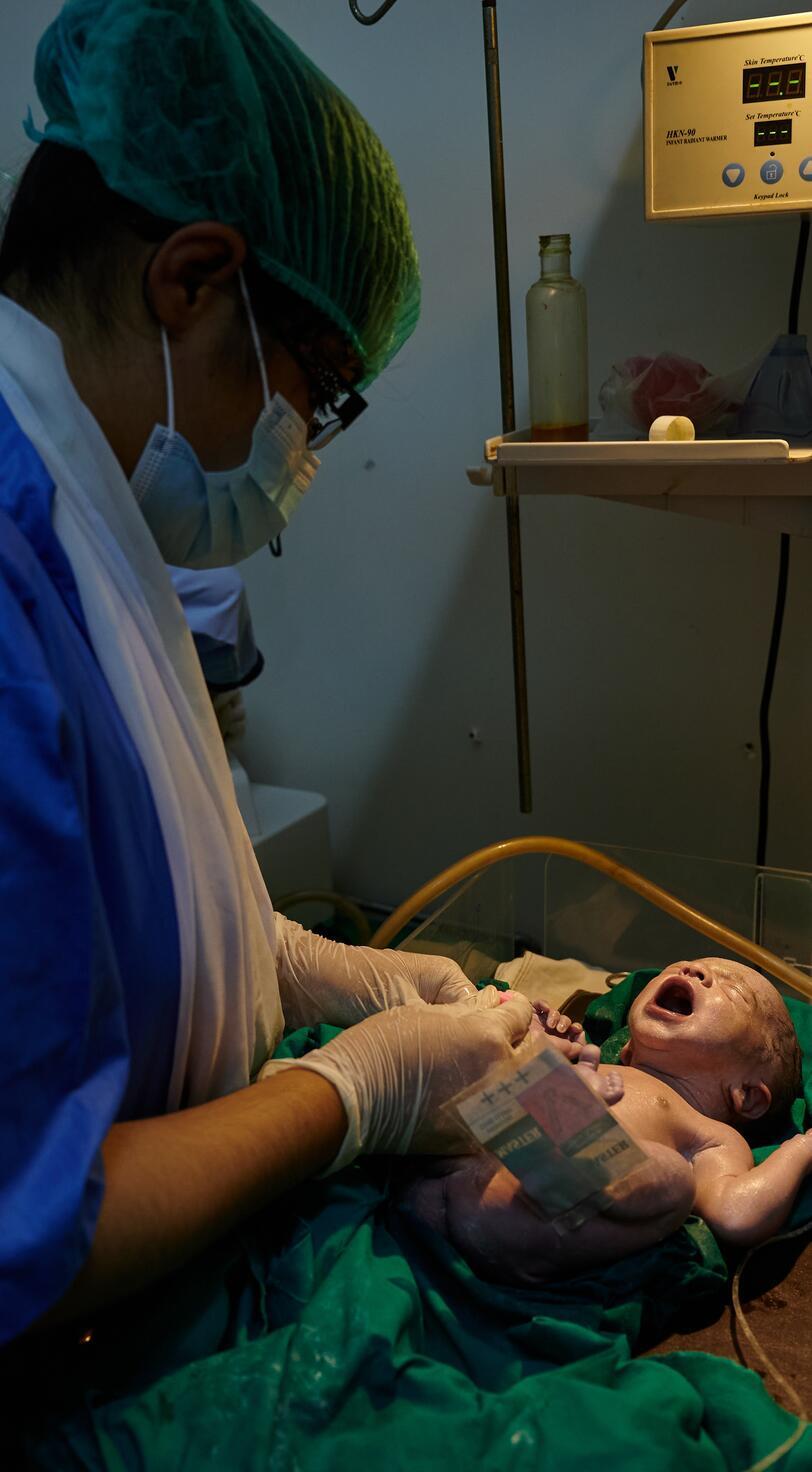 A nurse tends to a newborn baby.