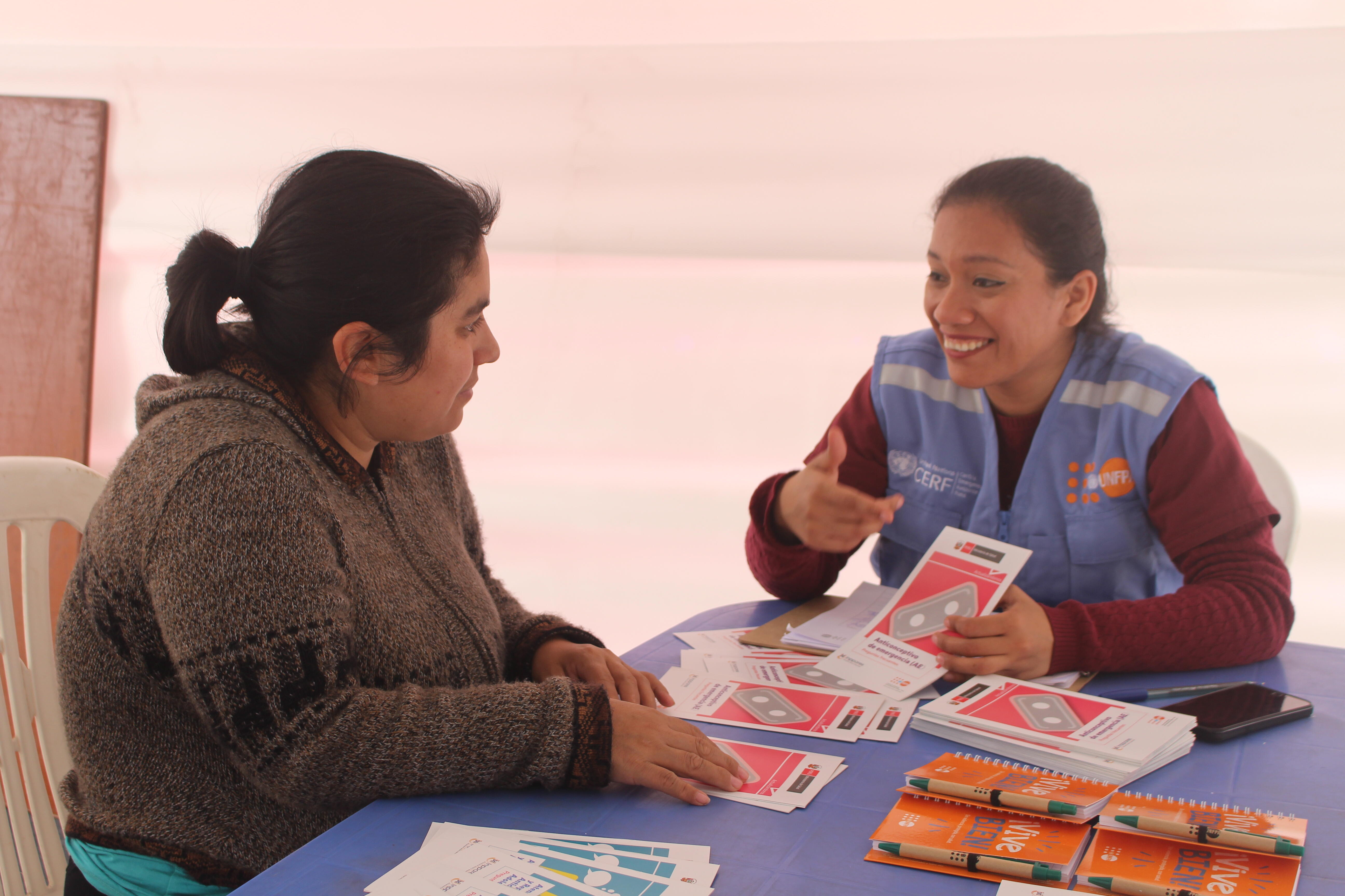 Woman speaks with UNFPA staff member