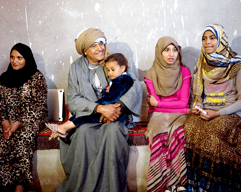 An Egyptian family sits inside their home.