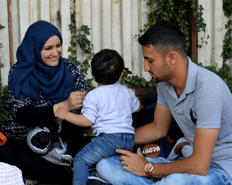 A young Syrian family on the border between Greece and Macedonia.