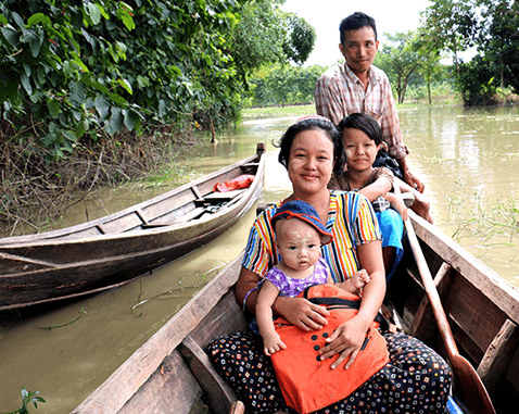 A family in a canoe after severe flooding.