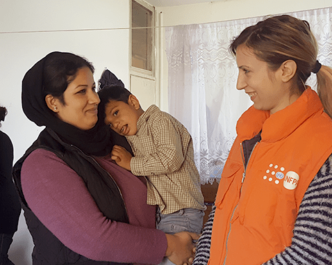 A refugee woman and her son meet with UNFPA staff.