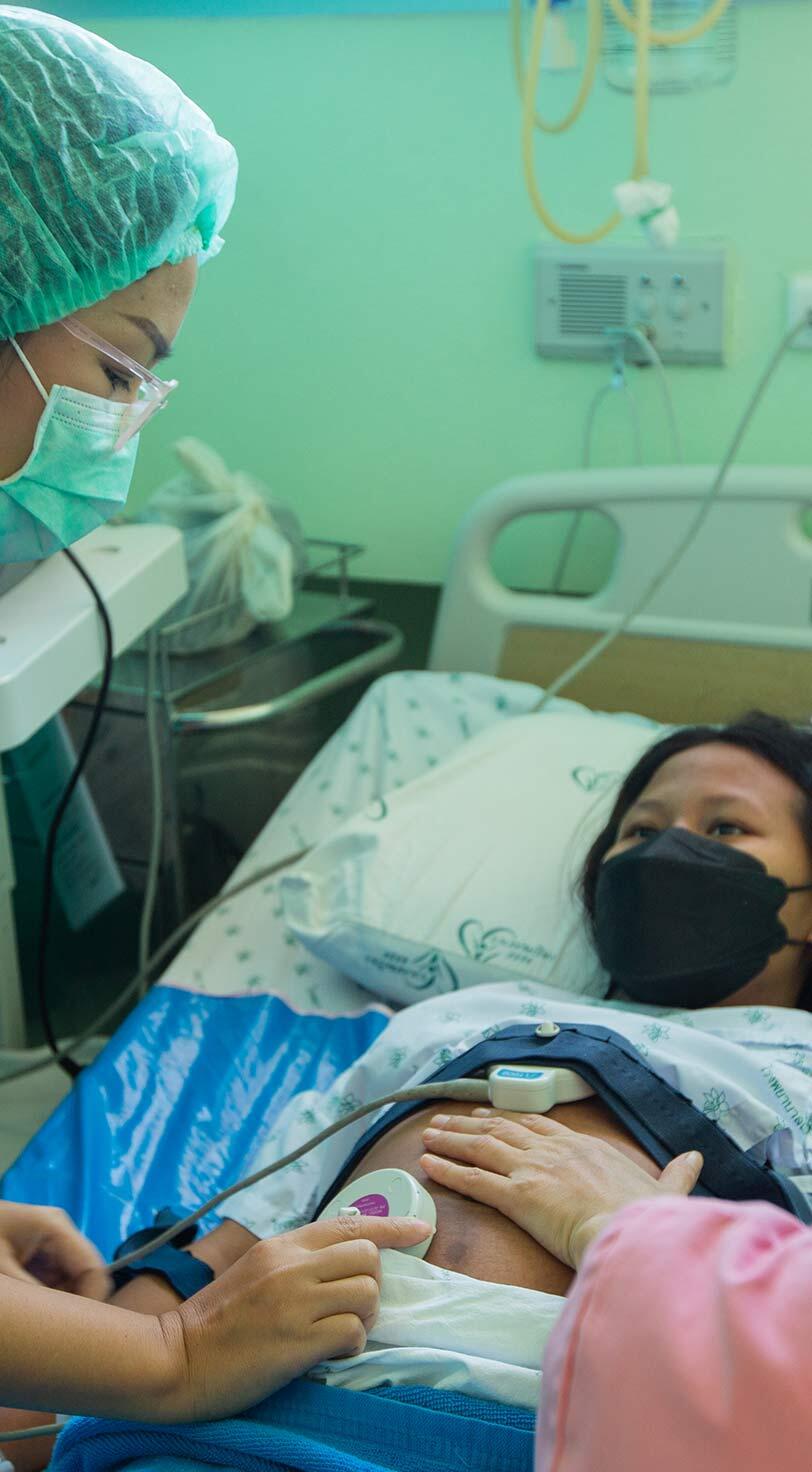 Demand for sexual and reproductive health services continued, even as supply chains were disrupted and health systems stretched. Midwives in a maternity ward in Thailand monitor a pregnant woman for potential complications.