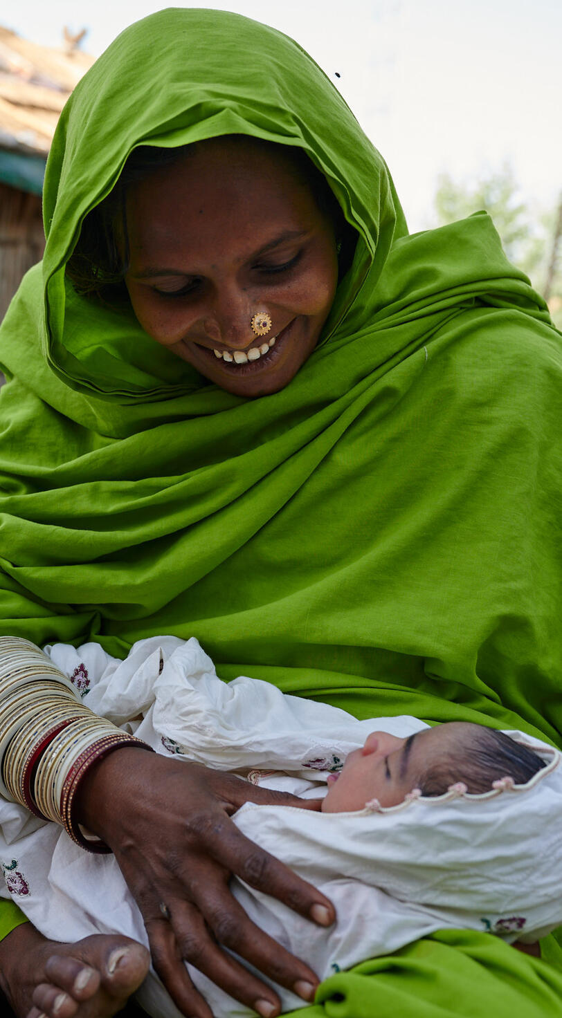 A woman holds her child.