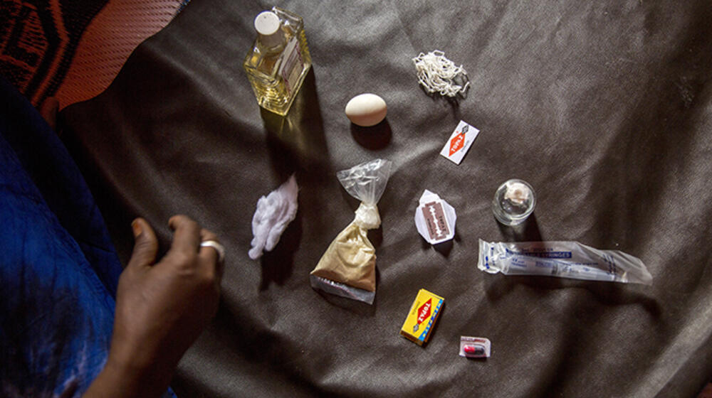 Asha lays out the tools she uses to perform female genital mutilation in Somalia. © UNFPA/Georgina Goodwin 
