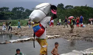 Venezuelan volunteers provide humanitarian relief to migrants,…